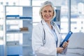 Portrait of a smiling female doctor holding clipboard Royalty Free Stock Photo