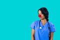 Portrait of a smiling female doctor or nurse wearing blue scrubs uniform Royalty Free Stock Photo