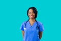 Portrait of a smiling female doctor or nurse wearing blue scrubs uniform Royalty Free Stock Photo