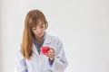 Portrait of smiling female doctor with red heart. Friendly young woman doctor with red heart on hand. asia Royalty Free Stock Photo