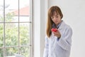 Portrait of smiling female doctor with red heart. Friendly young woman doctor with red heart on hand. asia Royalty Free Stock Photo