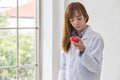 Portrait of smiling female doctor with red heart. Friendly young woman doctor with red heart on hand. Selective focus Royalty Free Stock Photo