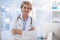 Portrait of a smiling female doctor standing with arms crossed Royalty Free Stock Photo