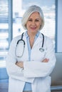 Portrait of a smiling female doctor standing with arms crossed Royalty Free Stock Photo