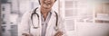 Portrait of a smiling female doctor standing with arms crossed Royalty Free Stock Photo
