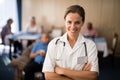 Portrait of smiling female doctor standing with arms crossed Royalty Free Stock Photo