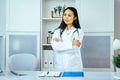 portrait of smiling female doctor with stethoscope arms crossed Royalty Free Stock Photo