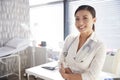 Portrait Of Smiling Female Doctor With Stethoscope Standing By Desk In Office Royalty Free Stock Photo