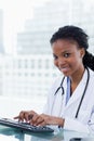 Portrait of a smiling female doctor using a computer Royalty Free Stock Photo