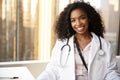 Portrait Of Smiling Female Doctor Wearing White Coat With Stethoscope In Hospital Office Royalty Free Stock Photo