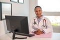Portrait of smiling female general practitioner at her workplace Royalty Free Stock Photo