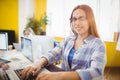 Portrait of smiling female graphic designer working with laptop Royalty Free Stock Photo