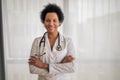 Portrait of smiling female healthcare worker standing with arms crossed Royalty Free Stock Photo