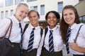 Portrait Of Smiling Female High School Students Wearing Uniform Outside College Building Royalty Free Stock Photo