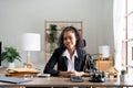 Portrait smiling female lawyer sitting at workplace in office Royalty Free Stock Photo