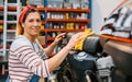 Portrait of smiling female mechanic cleaning motorcycle seat on factory Royalty Free Stock Photo