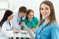 Portrait of smiling female medicine doctor with her three collea Royalty Free Stock Photo