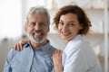 Portrait of smiling female nurse support mature patient