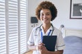 Portrait Of Smiling Female Nurse Wearing Uniform With Digital Tablet In Private Hospital Room Royalty Free Stock Photo