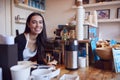 Portrait Of Smiling Female Owner Of Coffee Shop Standing Behind Counter Royalty Free Stock Photo