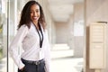 Portrait Of Smiling Female School Teacher Standing In Corridor Of College Building Royalty Free Stock Photo