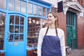 Portrait Of Smiling Female Small Business Owner Standing Outside Shop On Local High Street