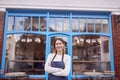 Portrait Of Smiling Female Small Business Owner Standing Outside Shop On Local High Street