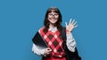 Portrait of smiling female student with laptop backpack, on blue background Royalty Free Stock Photo