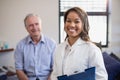 Portrait of smiling female therapist holding file with senior male patient Royalty Free Stock Photo