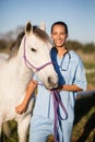 Portrait smiling female vet by horse Royalty Free Stock Photo