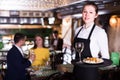 Portrait of smiling female waiter who is standing with tray Royalty Free Stock Photo