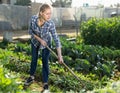 Woman hoeing in garden