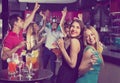 Portrait of smiling females and males having fun in the bar Royalty Free Stock Photo