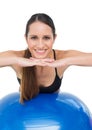 Portrait of a smiling fit woman stretching on fitness ball Royalty Free Stock Photo