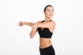 Portrait of a smiling fitness woman stretching her hands Royalty Free Stock Photo