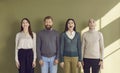 Portrait of smiling four surprised and amazed business people standing in row and looking up. Royalty Free Stock Photo