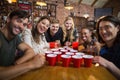 Portrait of smiling friends around disposable cups on table Royalty Free Stock Photo
