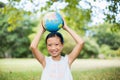 Portrait of smiling girl carrying a globe on her head Royalty Free Stock Photo