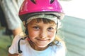 Portrait of a smiling girl child 5 years in a pink bicycle helmet close-up on the street Royalty Free Stock Photo