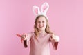 Portrait of smiling girl in dress pointing in camera on pink Royalty Free Stock Photo