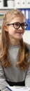 Portrait of smiling girl in glasses at doctor appointment.