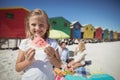 Portrait of smiling girl holding watermelon with parents in background Royalty Free Stock Photo