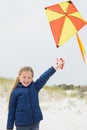 Portrait of a smiling girl with kite at beach Royalty Free Stock Photo