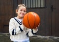 Portrait of a smiling girl looking at the camera with a basketball Royalty Free Stock Photo