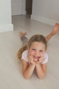 Portrait of a smiling girl lying on floor Royalty Free Stock Photo