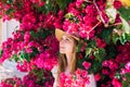 Portrait of smiling girl among purple bougainvillaea Royalty Free Stock Photo