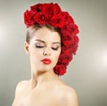 Portrait of smiling girl with red roses hairstyle Royalty Free Stock Photo