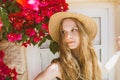 Portrait of smiling girl with tangled hair among purple bougainvillaea Royalty Free Stock Photo