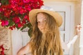 Portrait of smiling girl with tangled hair among purple bougainvillaea Royalty Free Stock Photo