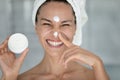 Portrait of smiling woman apply moisturizing face cream Royalty Free Stock Photo